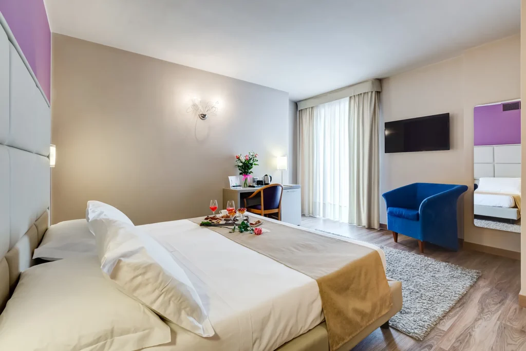 The image shows a room with a window and a double bed.