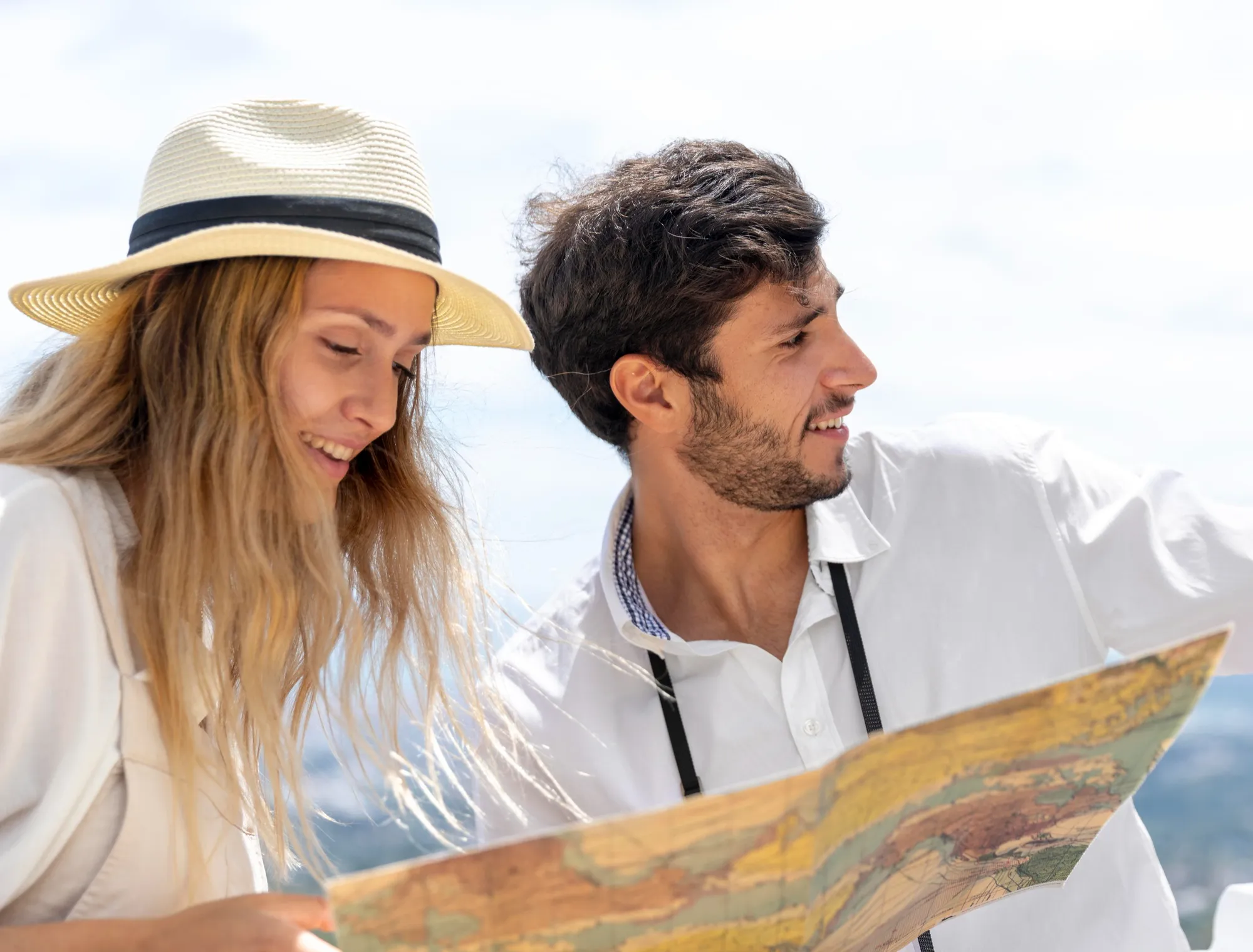 The image shows a young couple visiting the city with a map in their hands.