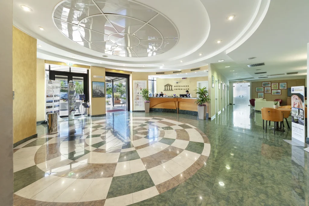 The image shows the hotel lobby and reception area.